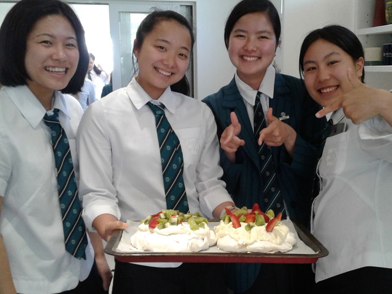 Four students showing their dessert